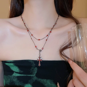 Gothic double-layered necklace with vintage cross pendant and red rhinestones on model