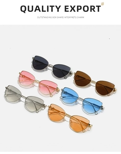 Flat lay of stylish cat-eye metal sunglasses in six different vibrant fashion colors