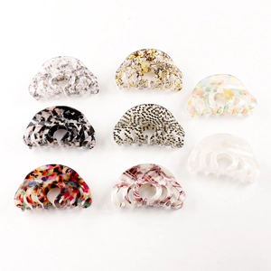 Set of eight assorted acetate hair claws with marble and tortoiseshell patterns