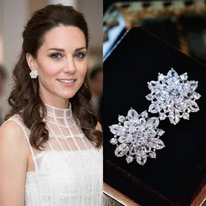 Detailed macro view of silver snowflake earrings with sparkling cubic zirconia crystals