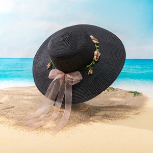 Women's black straw beach hat with wide brim, floral decor and pink ribbon tie