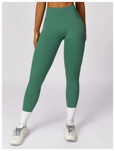 Macro shot of high-waist yoga pants in morandi green with seamless matte fabric texture