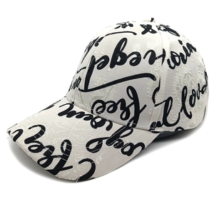 Detail of white baseball cap with black graffiti letters and textured jacquard fabric