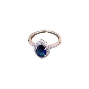 Silver hollow diamond ring featuring an oval blue zircon centerpiece with white accents