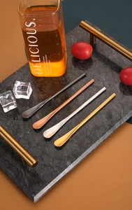 Macro detail of four assorted colorful long handle stainless steel dessert spoons