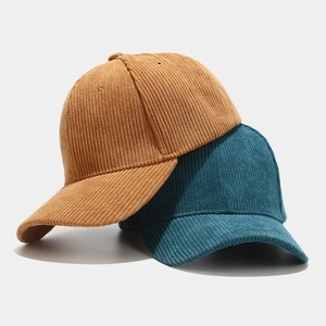 Retro corduroy baseball caps in mustard yellow and dark green with textured finish
