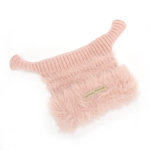 Detail of pink knitted hat with faux rabbit fur lining and woven brand label