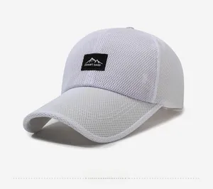 Detailed close-up of white mesh baseball cap featuring Mount Hood patch embroidery