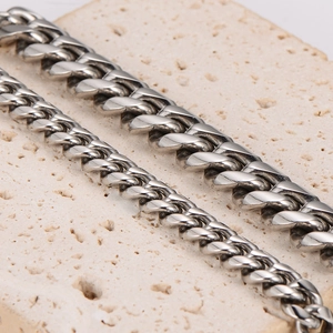 Men's minimalist stainless steel cuban link bracelets in two silver widths on stone