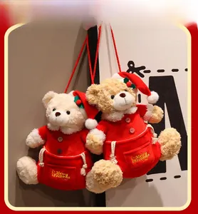 Detail of Christmas teddy bear plush storage bags with golden Merry Christmas embroidery