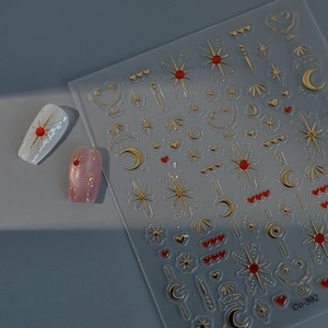 Macro view of 3D embossed gold star and moon nail stickers with metallic relief textures