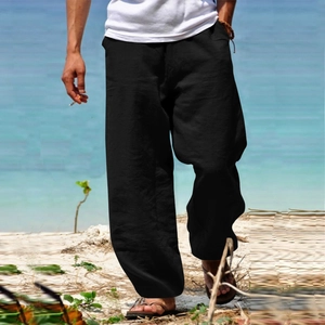Relaxed fit black cotton linen trousers for men styled for a casual beach vacation look