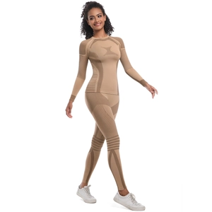 Detail of seamless knitted yoga set showing rib-textured sleeves and high-waist compression pants