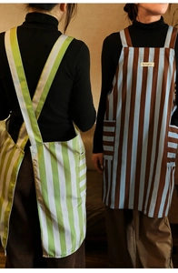Detail view of H-back striped kitchen aprons with large side pockets and cross straps
