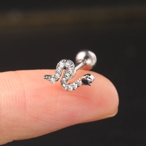 Macro detail of silver snake-shaped stud earring with cubic zirconia and ball back screw