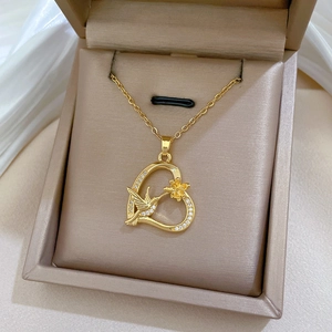 Luxurious gold titanium necklace with hummingbird heart pendant in a premium gift box