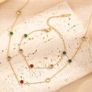 Luxurious gold titanium steel jewelry set featuring colorful round gemstones on chic chains