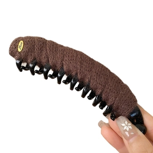 Plush brown banana hair clip with a gold Love metal accent for elegant winter hairstyling