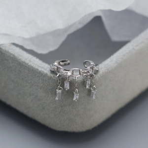 Macro view of S925 sterling silver ear cuff with cascading zirconia tassel pendants