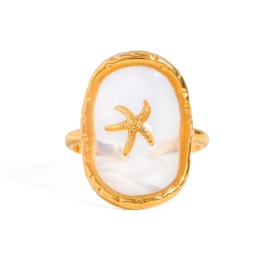 Gold stainless steel open ring featuring a starfish on a white oval resin inlay