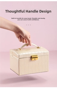 Detail of portable jewelry box handle and gold metal lock with crocodile leather texture