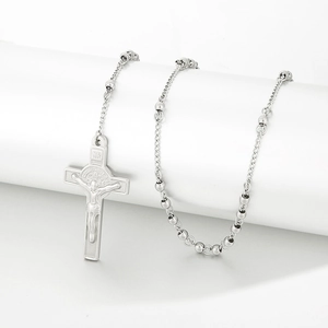 Detailed macro view of silver stainless steel rosary necklace with crucifix cross pendant