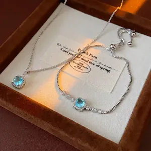 Silver jewelry set featuring square blue zircon necklace and adjustable slide bracelet