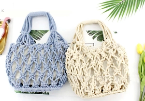 Detail of woven cotton tote bags in blue and beige with inner lining and knit straps