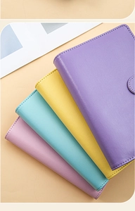 Detailed stack of colorful PU leather binder covers in purple, yellow, cyan and pink hues