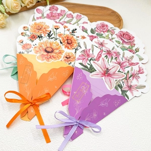 3D floral pop-up greeting cards with orange daisy and purple lily designs and ribbons