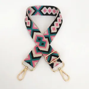 Detail view of colorful geometric diamond pattern woven strap with gold metal hooks