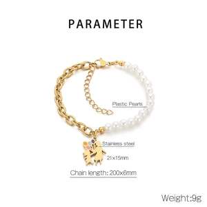 Detail view of steel chain and plastic pearls bracelet with heart mother-daughter charm