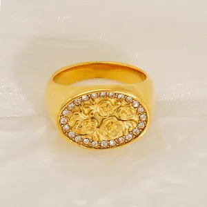 Retro golden stainless steel signet ring with floral relief and sparkling zircon halo