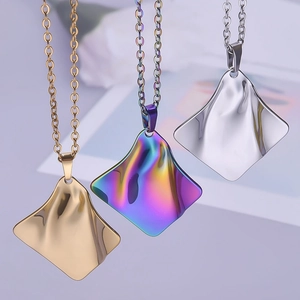 Close-up of wavy square pendants in gold, silver, and iridescent rainbow plated finishes