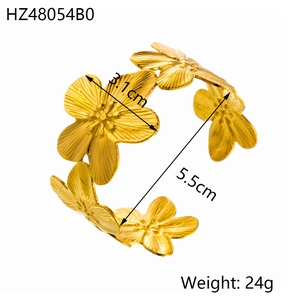Detail view of gold floral open bangle with dimensions 3.1cm flower and 5.5cm inner diameter