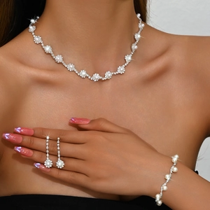 Luxurious silver bridal jewelry set with sparkling rhinestones and pearls on a model
