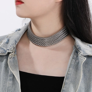 Detailed close-up of a silver stainless steel mesh chain necklace worn by a model
