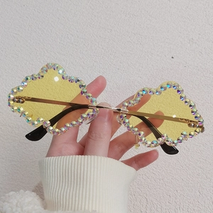 Cloud-shaped sunglasses with yellow lenses, rhinestone frames and thin gold metal arms