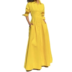 Detail of yellow long sleeve shirt dress featuring side pockets and button closure