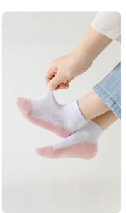 Close-up of pink breathable mesh socks for children showing elastic knit texture