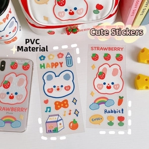 Detailed view of PVC cartoon stickers with bears and rabbits on a desktop layout