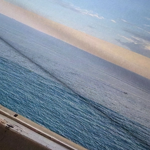 Close-up detail of the woven texture on sea landscape scenery hanging tapestry