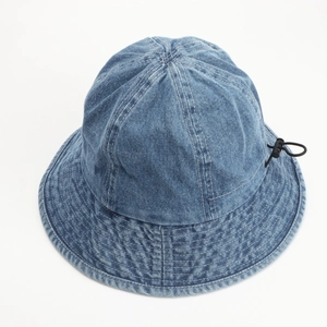 Close-up of dark blue denim bucket hat with reinforced stitching and adjustable drawstring