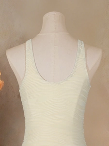 Detailed close-up of textured wavy knit fabric and U-neckline on off-white swimwear