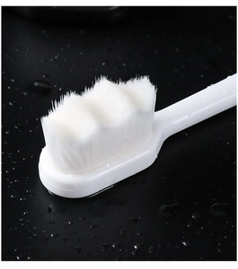Macro shot of high-density ultra-soft white bristles with water droplets on black background