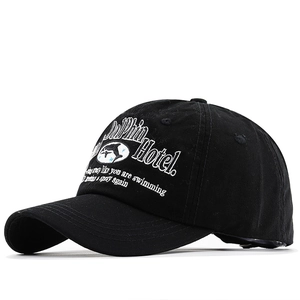 Classic black washed cotton baseball cap with white dolphin hotel embroidery detail