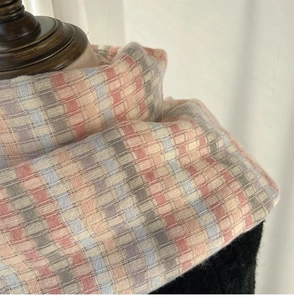 Close-up of the soft rainbow plaid scarf texture with high-quality knit details