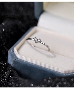 Close-up of S925 sterling silver heart ring with micro-pave zircons on blue velvet