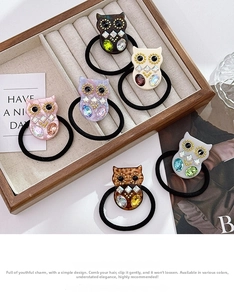 Detail of owl charms with crystals and rhinestones on high-elastic hair ties