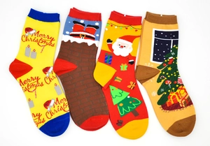 Detail view of four pairs of festive Christmas socks featuring Santa and tree patterns